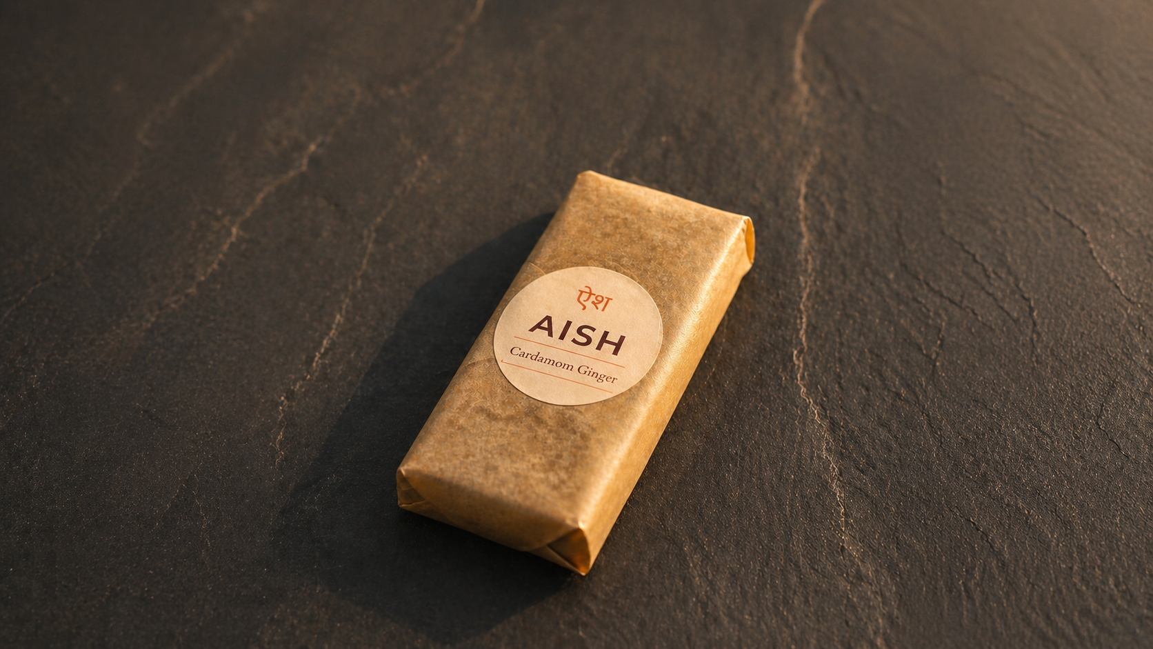 Abhi holding an AISH Cardamom Ginger protein bar
